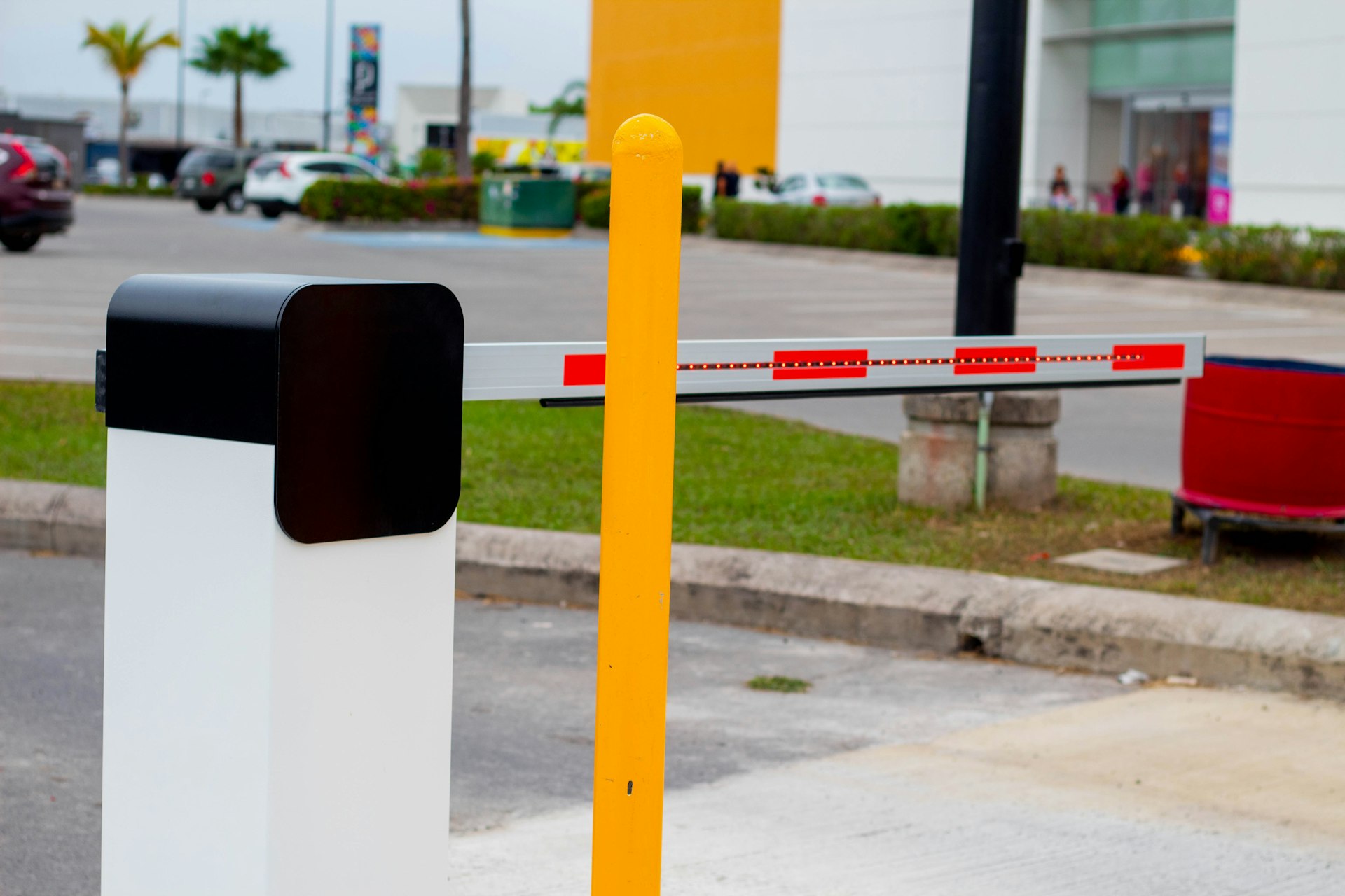 a yellow and white barrier sitting on the side of a road
